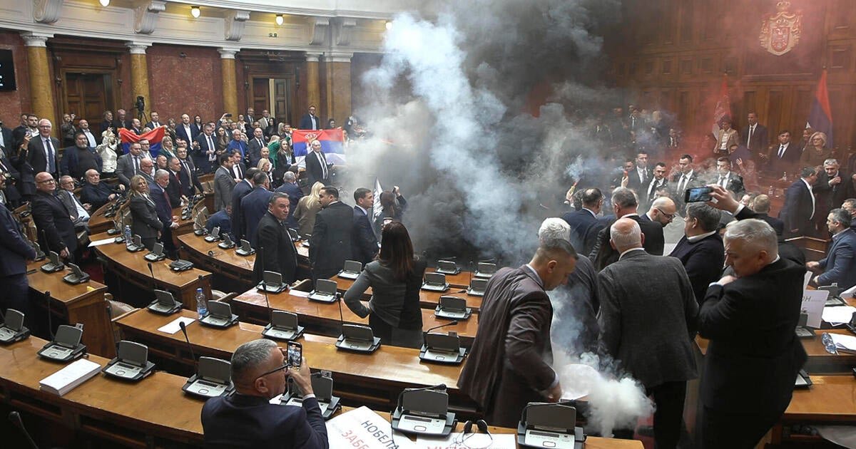 At least 3 lawmakers injured as smoke bombs and flares are thrown in Serbian parliament