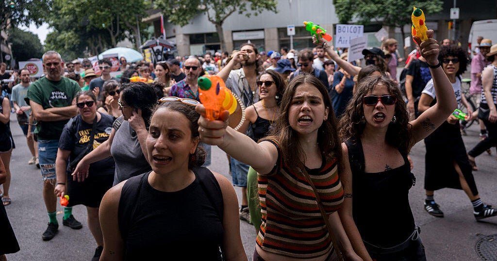 Protesters in Spain shoot water guns at tourists in demonstration against mass tourism, housing costs